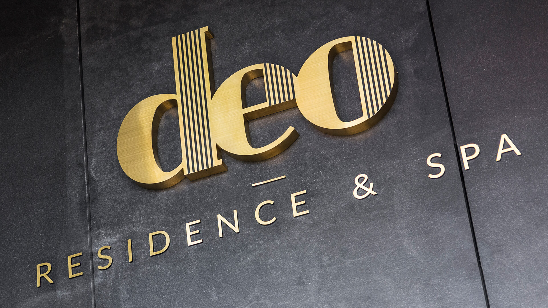 deo residenz deo hotel spa - deo-residence-lettering-from-safe-steel-brushed-lettering-over-entry-to-office-building-lettering-height-mounted-to-the-wall-lettering-on-capitals-lettering-on-desk-logo-firmowe-gdansk